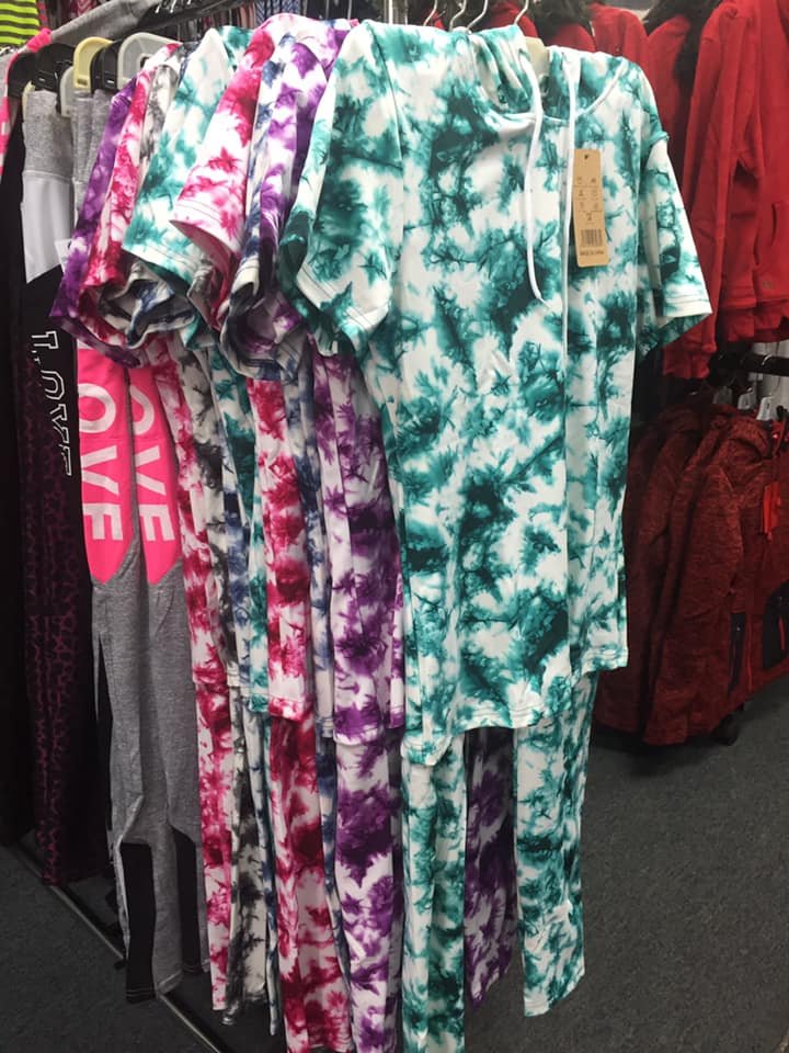 Colorful tie-dye loungewear and hoodies on a store rack